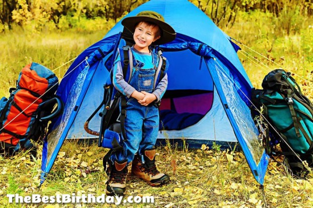 Boy by tent at camping party